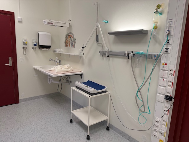 Et sykehusrom med vask og medisinsk utstyr