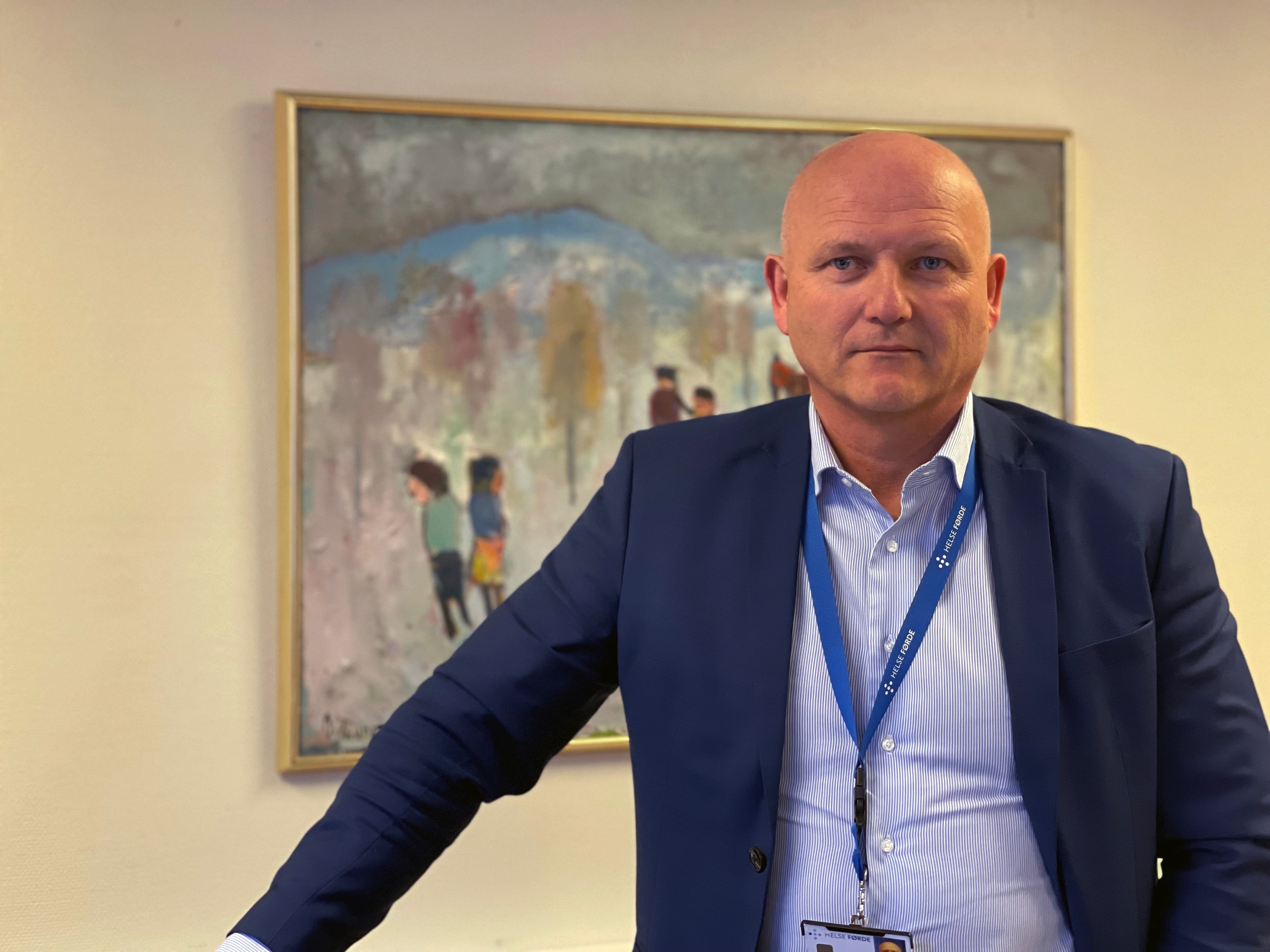 Ein mann som står framføre eit maleri