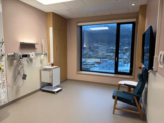 A room with a window and a chair